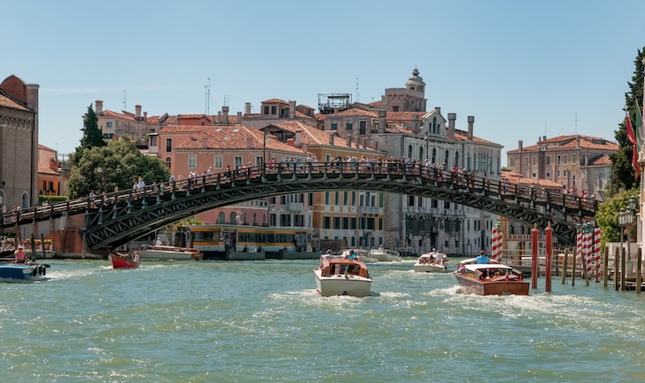 Venetian bridge with boats and buildings