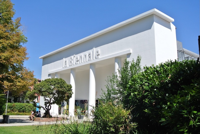 Modern white building with greenery.