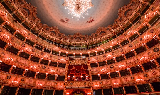 Opulent theater interior with chandeliers